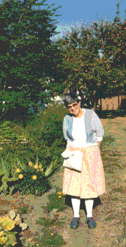 photo of mother in front of her fruit trees and garden